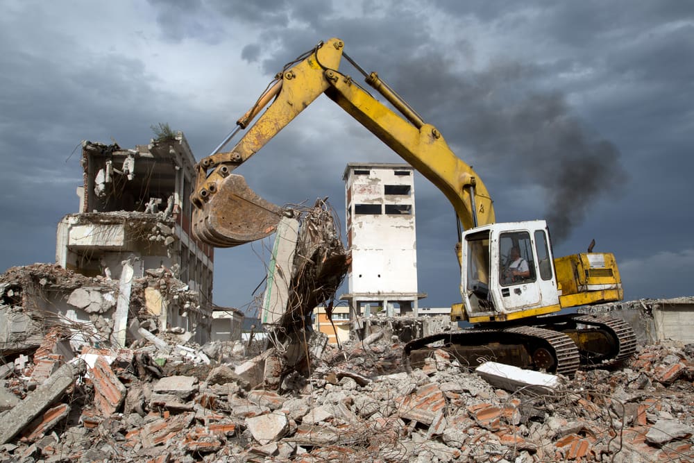Excavator demolishing a building