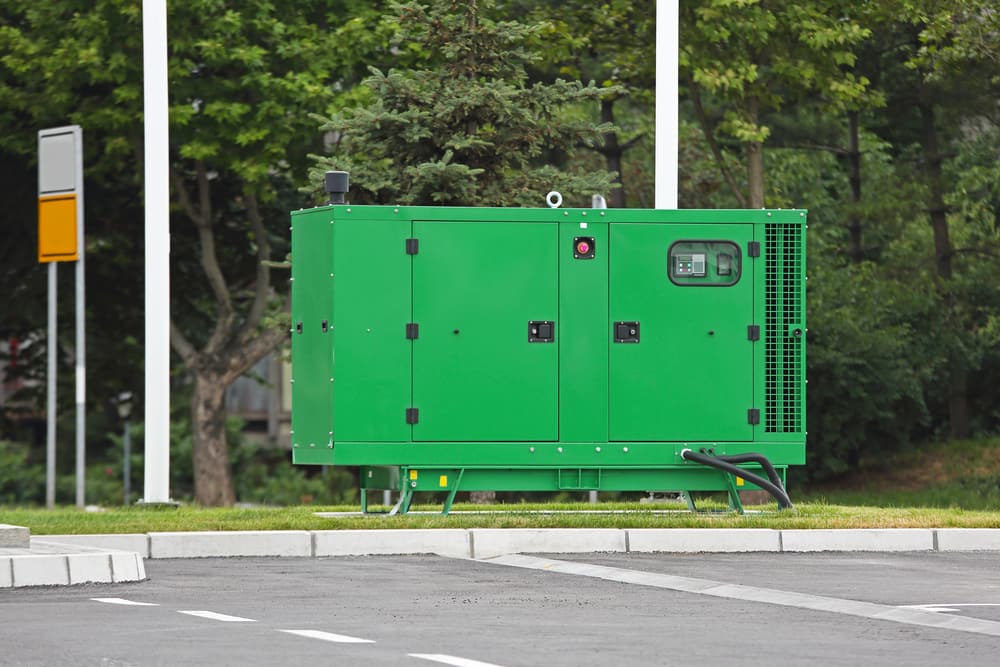 Outdoor diesel generator with exhaust stack running beside trees — diesel engine exhaust emissions source