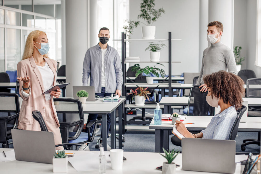 Office workers collaborating in a shared workspace