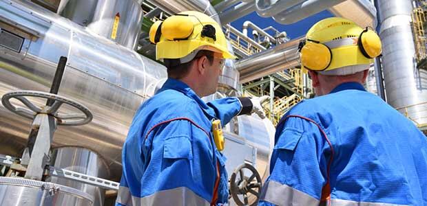 Hygienist fitting a personal sampling pump on a worker — workplace exposure monitoring